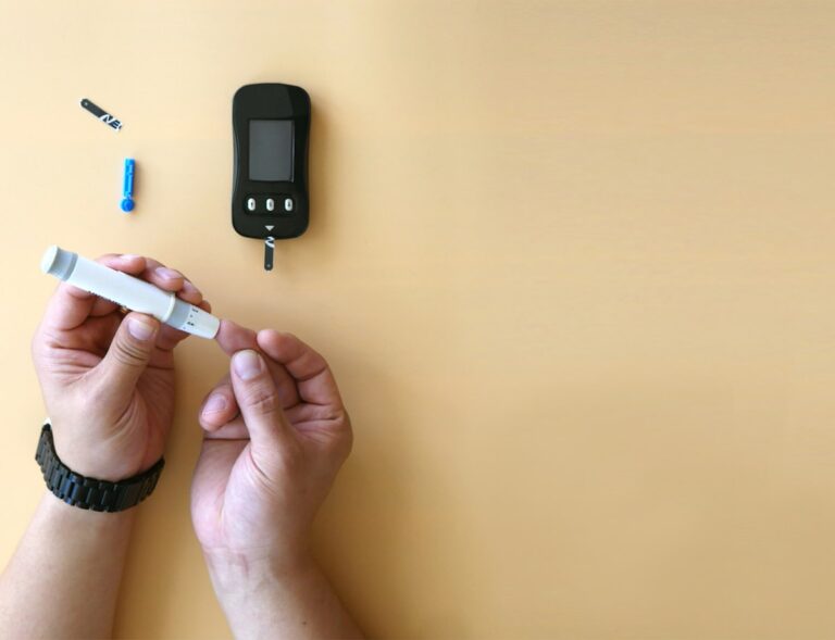 Checking blood sugar at home with a glucometer and lancet for diabetes management