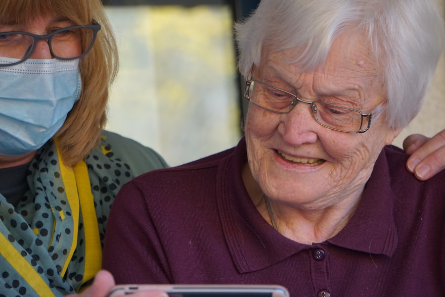 A home health nurse smiling with an elderly woman during an in-home visit