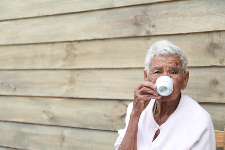 Senior woman drinking water to stay hydrated and safe in summer heat